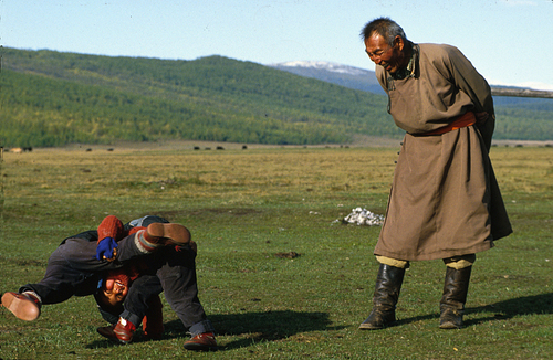 Young Mongolian wrestlers and gran pa referee