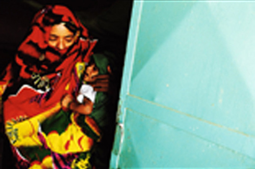 Mother Carrying Her Child Suffering From Malnutrition Out Of Hagaz Healthcare Center Eritrea