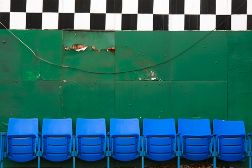 Green Wall with Blue Chairs