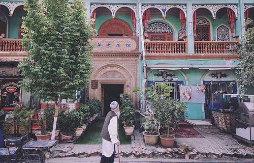 Uyghur Man Reflects in Front of 100-Yr-Old Site in Xinjiang
