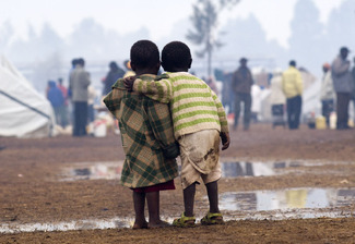 Two children stand together during heavy rainfall in a displaced persons camp in Kenya's Rift Valley Color Awards Winners and Nominees