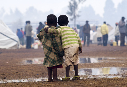Two children stand together during heavy rainfall in a displaced persons camp in Kenya's Rift Valley Two children stand together during heavy rainfall in a displaced persons camp in Kenya's Rift Valley