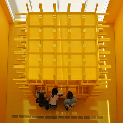 3 people and a yellow cube