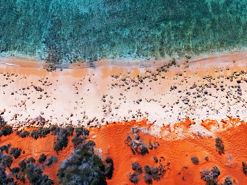 Red desert meets turquoise waters